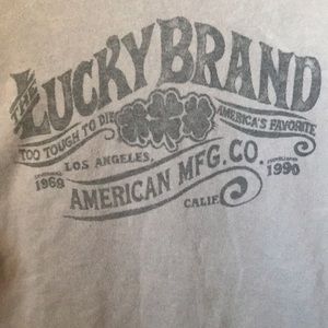 Lucky Brand Men Graphic T-Shirt Size XL. Light Brown with Dark Gray Graphics.